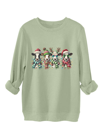 Four cows wearing hats scarves thick hoodies