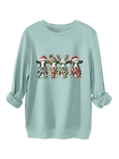 Four cows wearing hats scarves thick hoodies