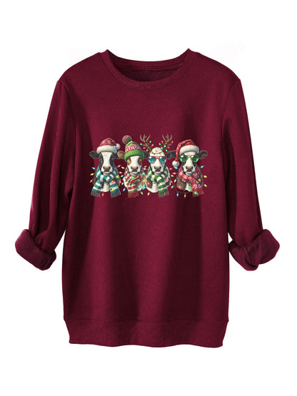 Four cows wearing hats scarves thick hoodies