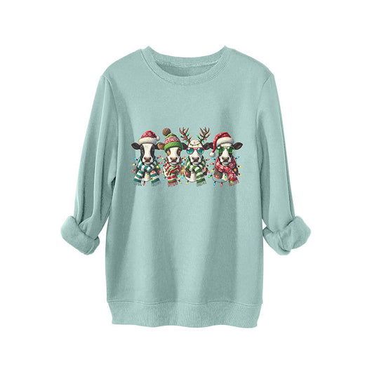 Four cows wearing hats scarves thick hoodies